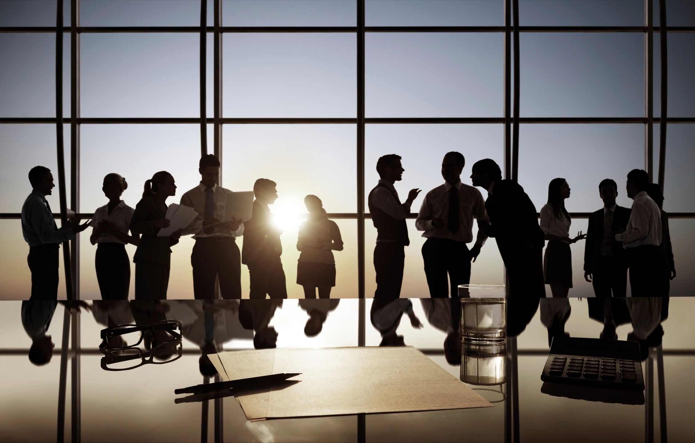 A group of people standing around a table.