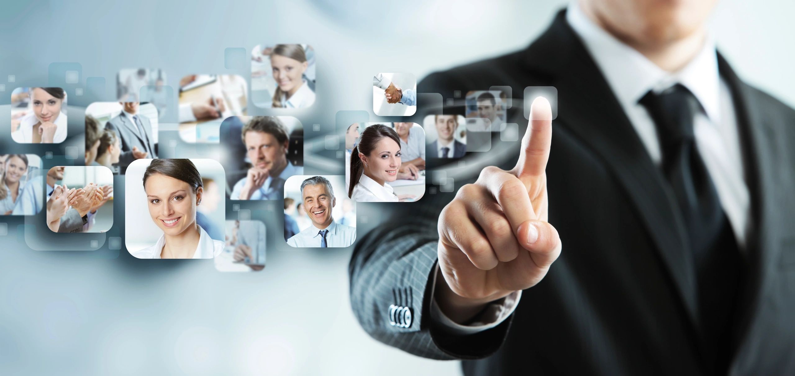 A man in suit and tie pointing to multiple images of people.